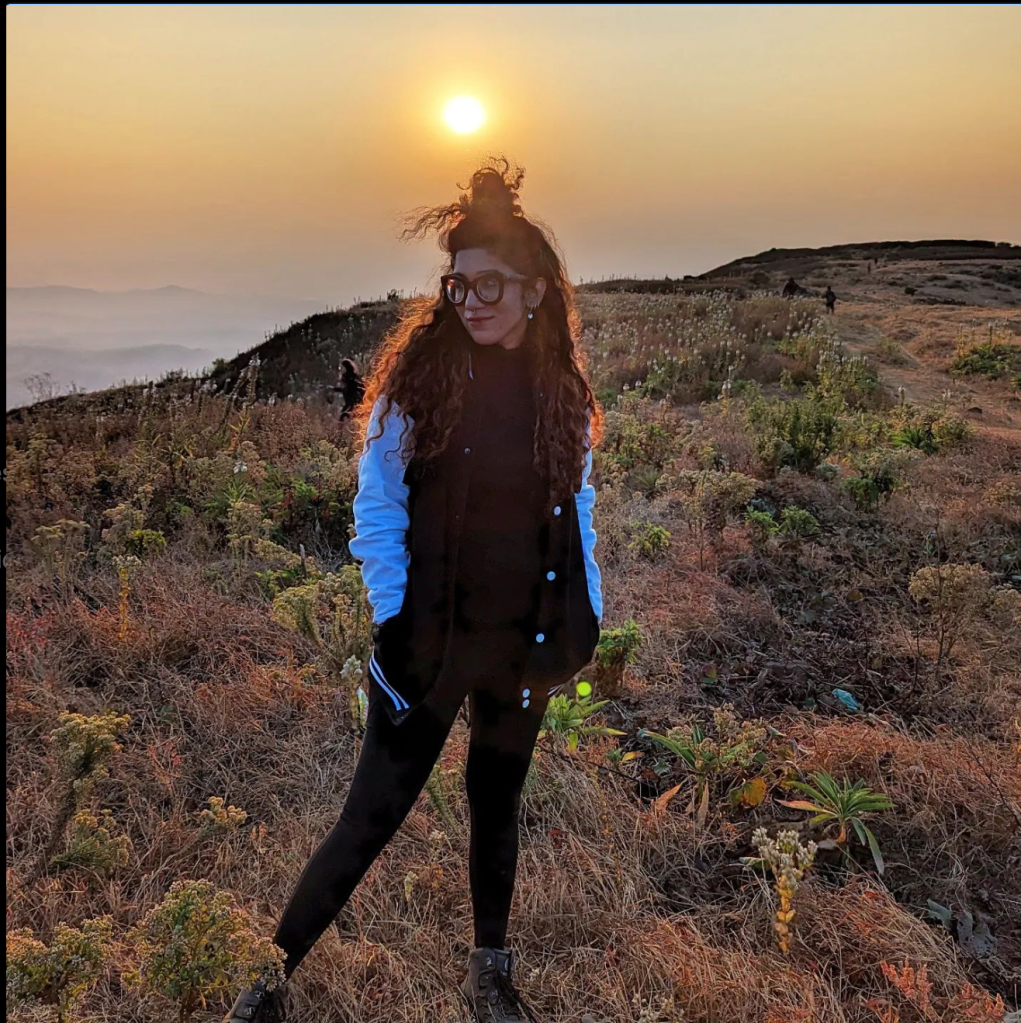 A girl standing on the top of Kalsubai in Maharashtra, India. 
